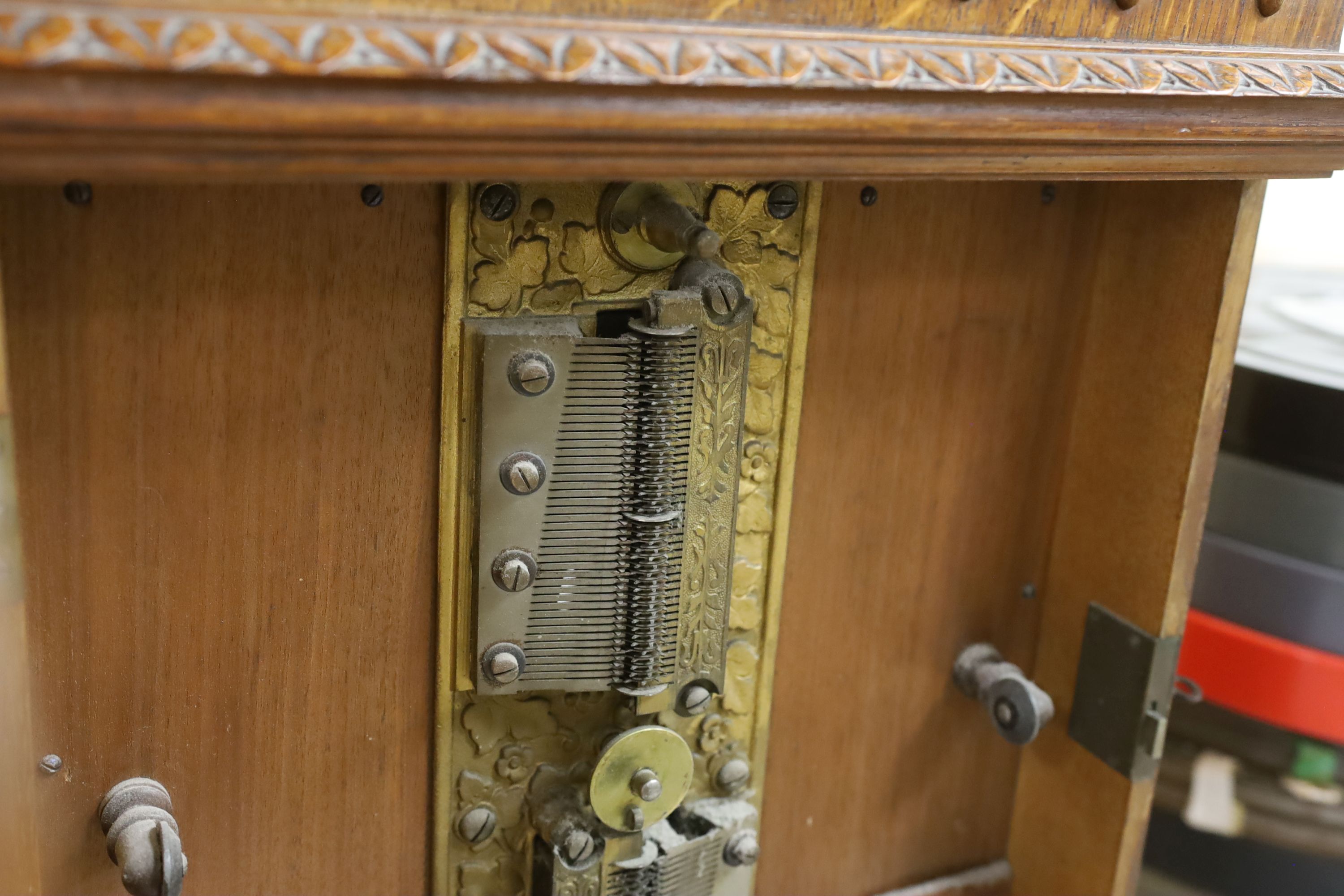 An oak cased penny operated polyphon (a.f.), with one 12 inch disc, dimensions; 76cm high, 52cm wide, 32cm deep